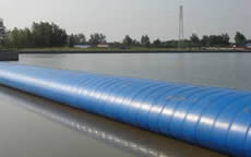 A blue air filled inflatable rubber dam